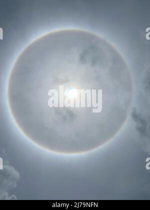 Sun halo from upper atmosphere ice - Grenada, Caribbean, mid-day May 7th 2022 Stock Photo