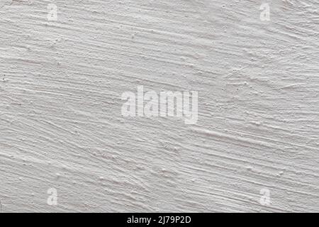 The background is in the form of gray rough plaster on the wall, whitewashed with chalk. Stock Photo