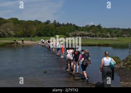 Crossing the Ogmore River on Stepping Stones, near Ogmore On Sea, Glamorgan Stock Photo