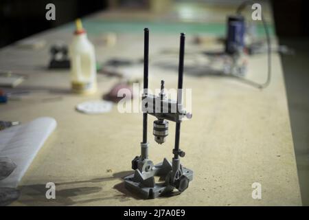 Hand drill on table. Tools in garage. Hole drilling tool. Details of metal workshop. Stock Photo