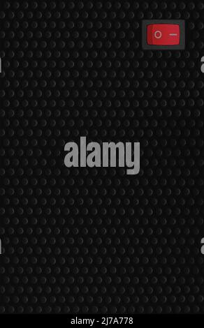 Red rectangle rocker power switch in on position, black abstract dot texture frame pattern, natural blank empty copy space background, mains supply Stock Photo