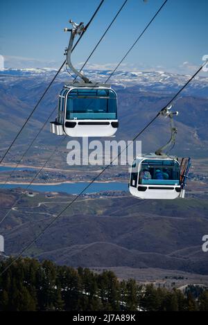 Gondola lift going up at the Snowbasin Ski Resort in Utah. Breathtaking view to the valley. Stock Photo