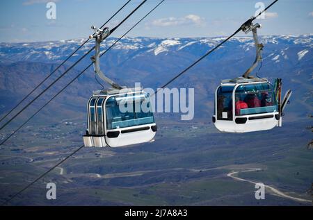 Gondola lift going up at the Snowbasin Ski Resort in Utah. Breathtaking view to the valley. Stock Photo