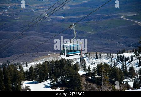 Gondola lift going up at the Snowbasin Ski Resort in Utah. Breathtaking view to the valley. Stock Photo