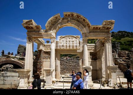 May 7, 2022, izmir, Istanbul, Turkey: Hadrian's temple ruins with tourists walking around in ancient city of Ephesus. Ephesus was an ancient port city whose well-preserved ruins are in modern-day Turkey. The city was once considered the most important Greek city and the most important trading center in the Mediterranean region. (Credit Image: © Serkan Senturk/ZUMA Press Wire) Stock Photo