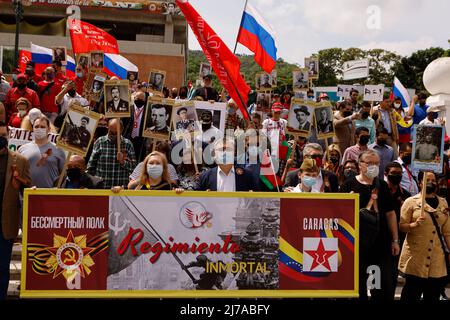 07 May 2022, Venezuela, Caracas: People carry photos of participants in World War II and Russian as well as other flags during a demonstration ahead of the 'Victory Day' celebrations, traditionally held in Russia on May 09, commemorating the victory over the Hitler regime and the German Wehrmacht. In the front, center, the Russian ambassador to Venezuela, Sergei Melik-Baghdazarov, can be seen. Venezuela is considered Russia's closest ally in Latin America. Photo: Jesus Vargas/dpa Stock Photo