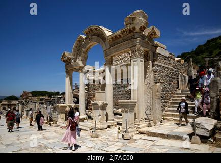 May 7, 2022, izmir, Istanbul, Turkey: Hadrian's temple ruins with tourists walking around in ancient city of Ephesus. Ephesus was an ancient port city whose well-preserved ruins are in modern-day Turkey. The city was once considered the most important Greek city and the most important trading center in the Mediterranean region. (Credit Image: © Serkan Senturk/ZUMA Press Wire) Stock Photo