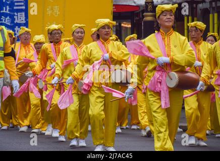 May 7, 2022, London, England, United Kingdom: Practitioners march in Whitehall. Falun Dafa (also known as Falun Gong) practitioners marched through central London to Downing Street on the 30th anniversary of the founding of the movement, to celebrate the practice and to raise awareness of the persecution faced by the practitioners in China. Falun Gong combines meditation and Qigong exercises with moral philosophy, and has been subjected to an ongoing crackdown by the Chinese Communist Party. (Credit Image: © Vuk Valcic/ZUMA Press Wire) Stock Photo