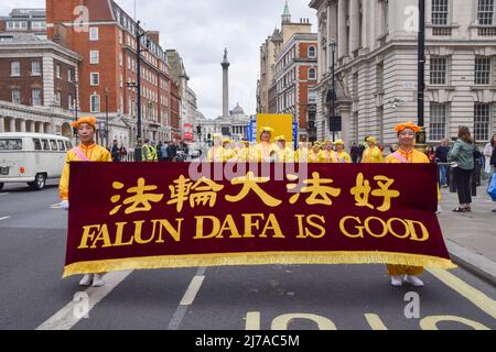 May 7, 2022, London, England, United Kingdom: Practitioners march in Whitehall. Falun Dafa (also known as Falun Gong) practitioners marched through central London to Downing Street on the 30th anniversary of the founding of the movement, to celebrate the practice and to raise awareness of the persecution faced by the practitioners in China. Falun Gong combines meditation and Qigong exercises with moral philosophy, and has been subjected to an ongoing crackdown by the Chinese Communist Party. (Credit Image: © Vuk Valcic/ZUMA Press Wire) Stock Photo