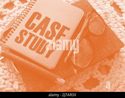 Case study memo written on a notebook with pen, glasses on crochet cloth. Successful business cases educational concept Stock Photo