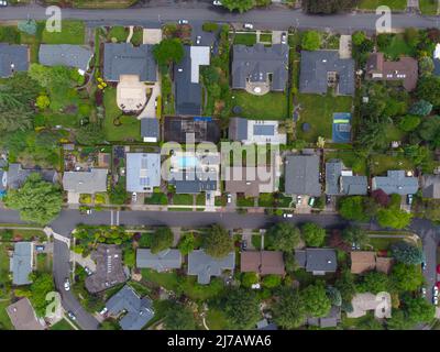 Shooting from the air. Small town, suburb. Roofs of small houses. Lots of greenery, roads. Planning, maps, topography, construction, housing, travel, Stock Photo