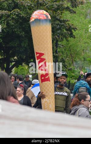 Participant is seen marching holding a giant blunt through Broadway from 32nd Street to Union Square in New York City during the annual Cannabis Parad Stock Photo