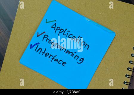 Concept of Application, Programming, and Interface write on sticky notes isolated on Wooden Table. Stock Photo