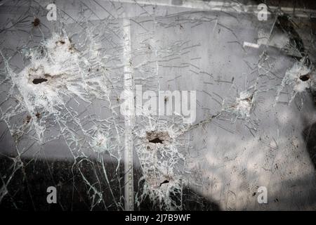 Multiple bullet holes seen on the glass of a shop in Saltivka, northeast Kharkiv. As Russia has re-supply its troops and concentrated the offensive on the eastern part of Ukraine, Kharkiv, the second biggest city in Ukraine now under constant threat of Russian bombardment and airstrikes. Russia invaded Ukraine on 24 February 2022, triggering the largest military attack in Europe since World War II. Stock Photo