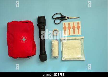 Directly above shot of first aid kit against blue background Stock Photo