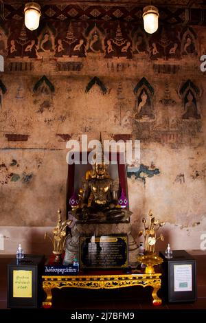 Ancient buddha statues in old ubosot church for thai people travelers visit and respect praying blessing holy worship at Wat Chomphuwek or Chumpoo Wek Stock Photo