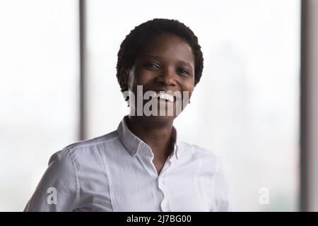 Happy millennial African businesswoman in formal shirt head shot portrait Stock Photo