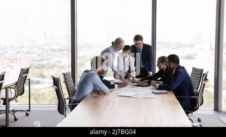 Team of interns and teacher studying marketing, working on startup Stock Photo