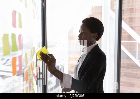 Focused confident Black business leader woman preparing project plan Stock Photo