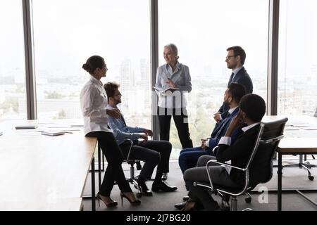 Middle aged female business coach training interns Stock Photo