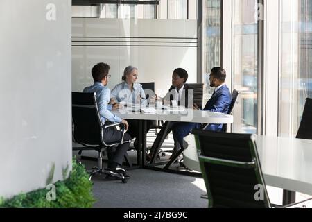 Multiethnic business team discussing project in meeting room Stock Photo