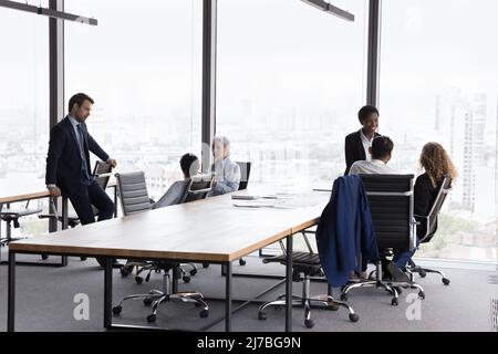 Two diverse business team gathering separately in modern office Stock Photo