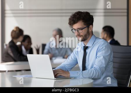 Serious young startup leader guy working on project Stock Photo