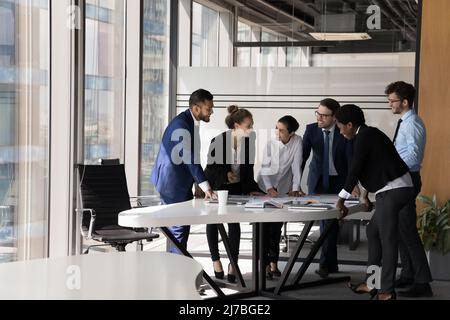 Diverse group of happy employees analyzing reports together Stock Photo