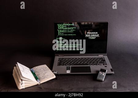 Concept of hacking and malware. Hacker using an abstract laptop with a binary code digital interface. Young hacker in cybersecurity concept. Stock Photo