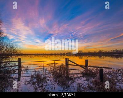 Dramatic evening sky after sunset above the Ouse Washes in winter flood, Sutton Gault, Cambridgeshire Stock Photo