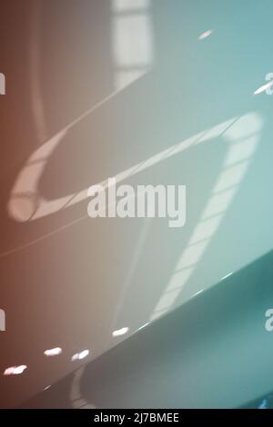 Shiny metallic paint texture with reflections and a bend, painted with a gradient of blue and orange Stock Photo