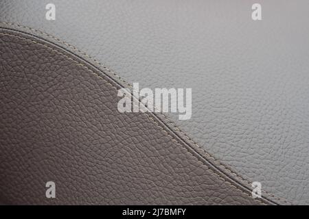 Detail of brown leather texture with a stitching in form of S Stock Photo