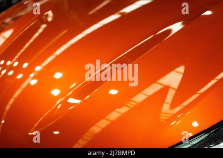 Metallic curved shiny orange texture with reflections Stock Photo