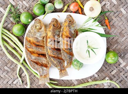 Top View Crispy fish with local platter with various vegetables as a side dish, ready to serve Stock Photo