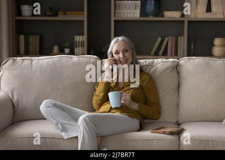 Happy pretty mature woman speaking on mobile phone portrait Stock Photo