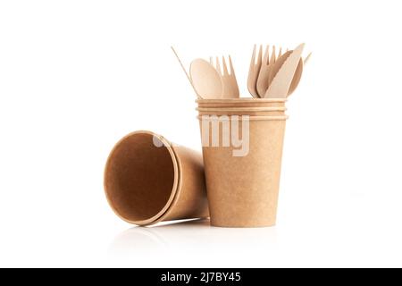 Kitchenware consisting of eco friendly disposable wooden cutlery and paper cup on white background. Wooden fork, knife and spoon in a paper cup. Zero Stock Photo
