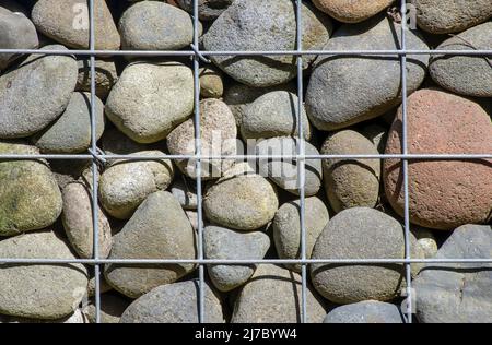 Gabion wall cages stones texture background Stock Photo