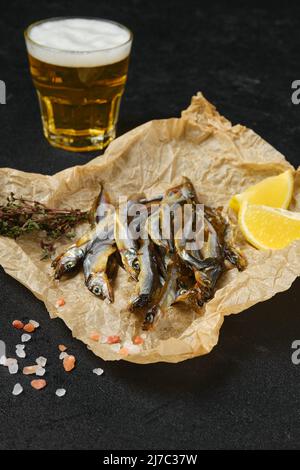 Fatty smoked smelt in wrapping paper Stock Photo