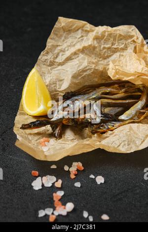 Fatty smoked smelt in wrapping paper Stock Photo