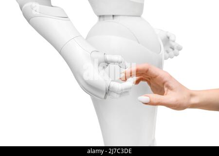 Hands of woman and futuristic humanoid robot on white background, closeup Stock Photo