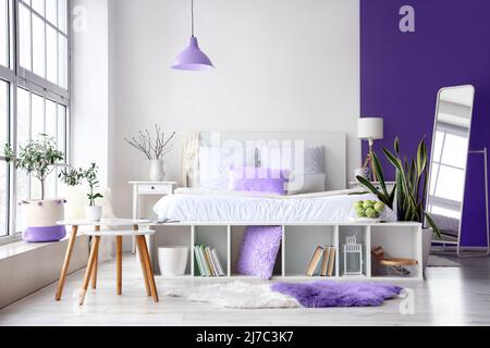 Interior of stylish bedroom with mirror and big window Stock Photo