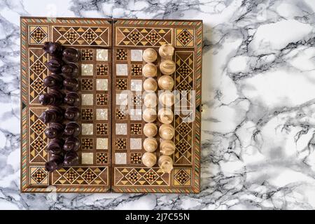 Top view of a chess game on alabaster stone table Stock Photo