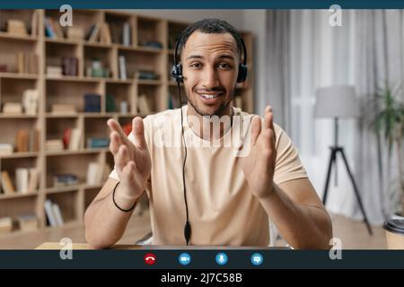 Web conference concept. Happy arab man making video call via laptop, talking and gesturing to webcamera, screenshot Stock Photo