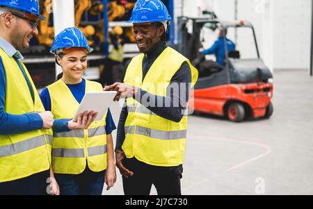 Multiethnic engineers working inside robotic factory - Industrial and technology concept - Main focus on woman face Stock Photo
