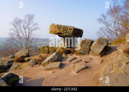 Eroded gritstone rock called the Druids Desk on a misty day in North Yorkshire Stock Photo