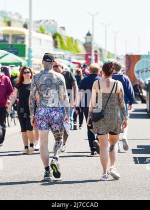 Brighton UK 8th May 2022 - Visitors enjoy a hot sunny day on Brighton beach and seafront as temperatures are forecast to reach over 20 degrees in some parts of the UK  : Credit Simon Dack / Alamy Live News