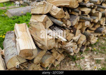 Shadow depth of field (selective focus) details with a pile of firewood in rural Romania. Stock Photo