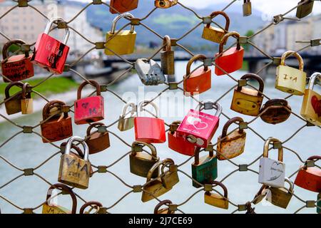 Love padlocks on the Makartsteg Bridge across the Salzach River in Salzburg, Austria. Stock Photo