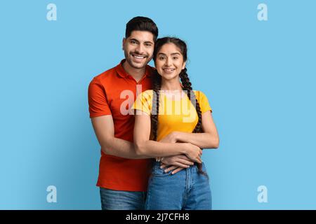 Portrait Of Smiling Young Middle Eastern Couple Embracing And Looking At Camera Stock Photo