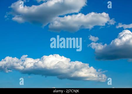 blue sky with fluffy clouds Cumulus, Stratocumulus, clouds lit by side light, background with clouds Stock Photo